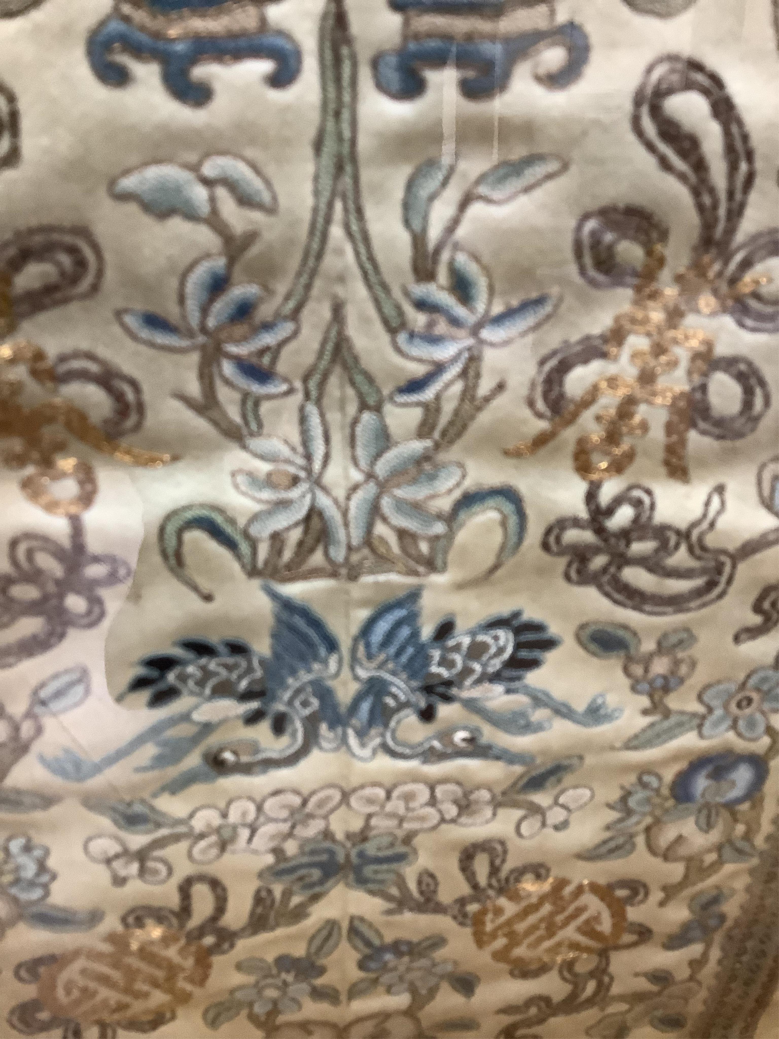 Two pairs of 19th century Chinese, Peking knot, silk embroidered sleeve bands. Worked on cream silk. Both embroidered mostly in blues and gilt thread, in flower, bird and auspicious motifs, both bordered with black silk
